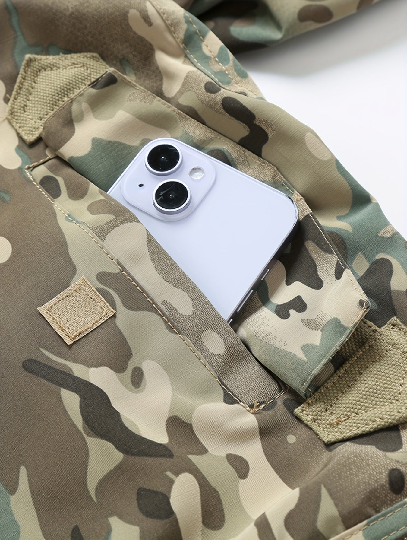 White smartphone in a camouflage pocket