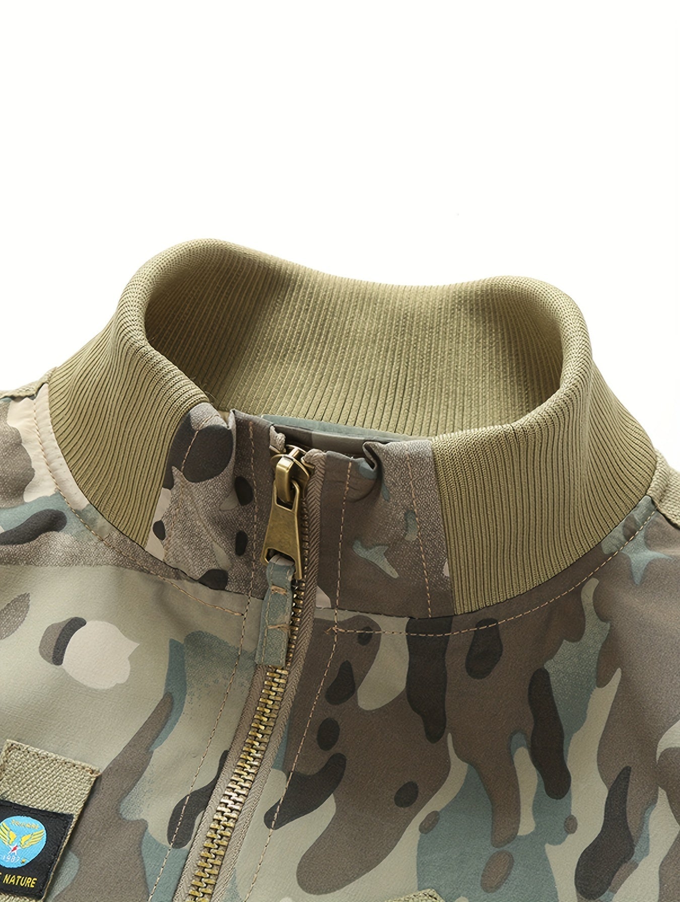 Camouflage jacket with a gold zipper on a white background