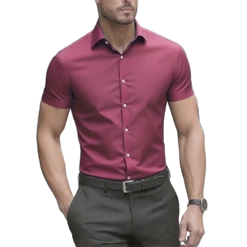 Man wearing a maroon short-sleeve shirt and dark pants outdoors