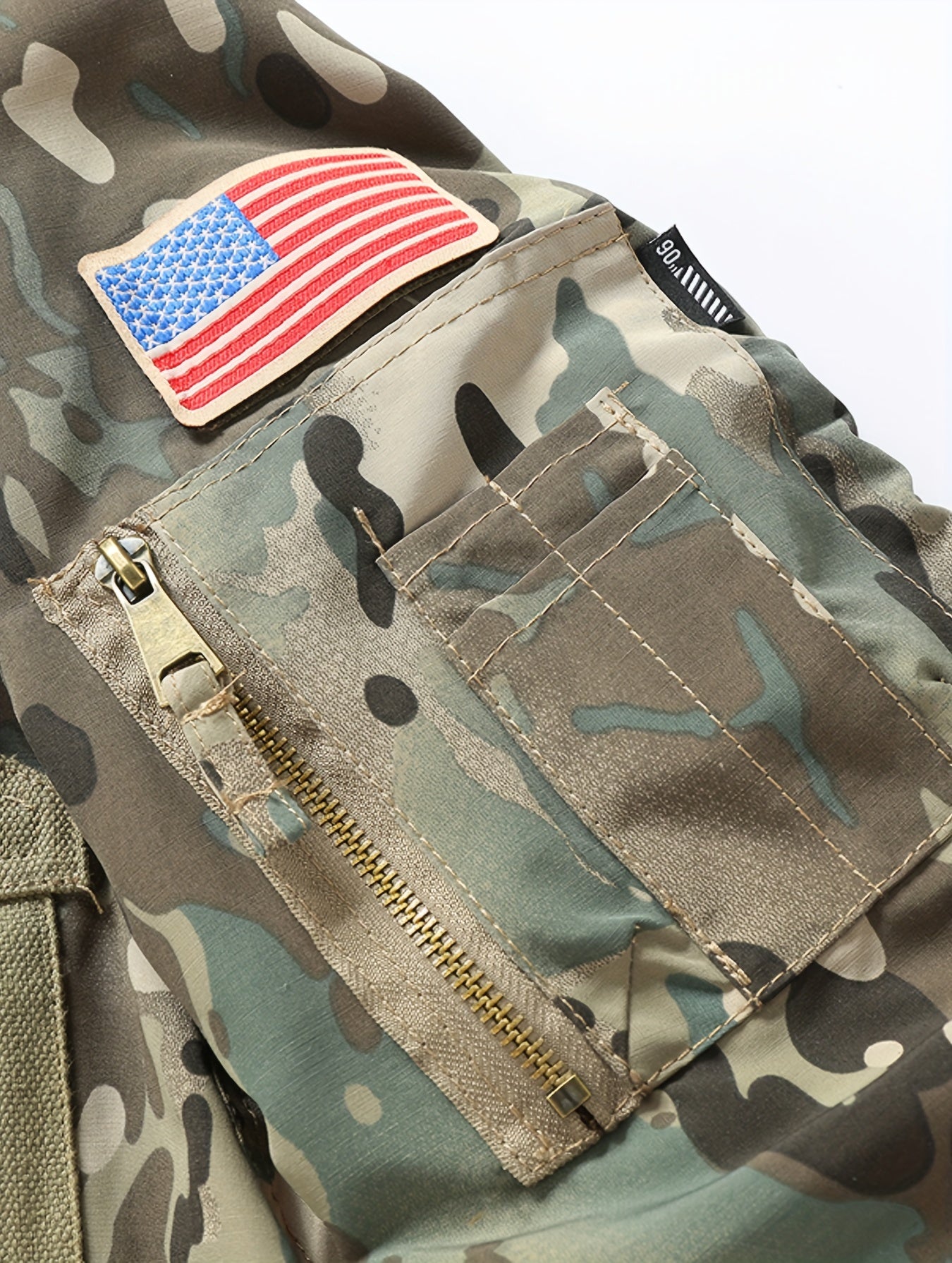 Camouflage jacket with American flag patch and visible brand name