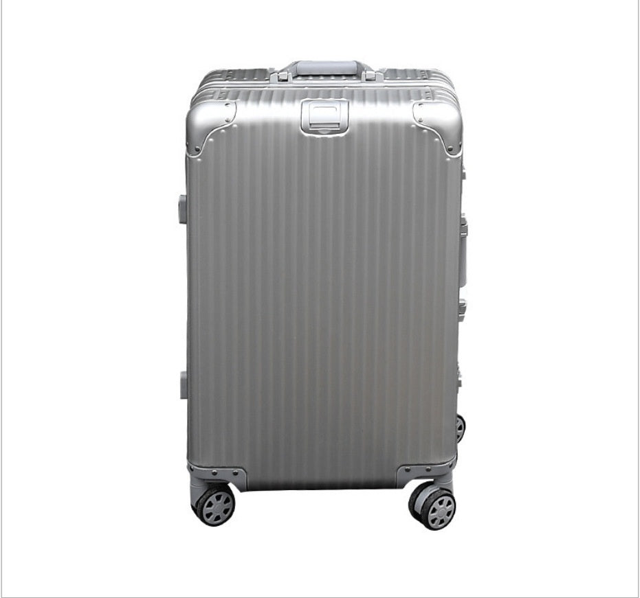 Silver suitcase with a ribbed texture on a white background