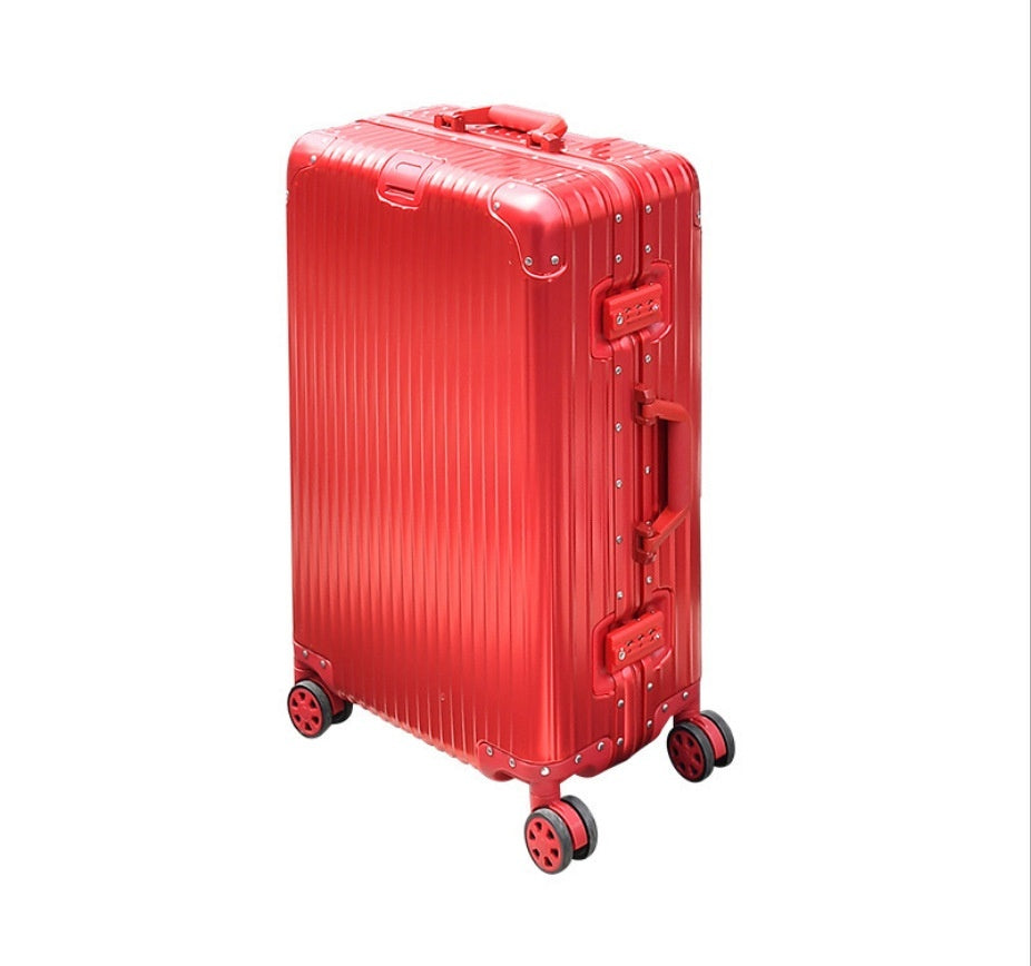 Red suitcase with a ribbed texture on a white background
