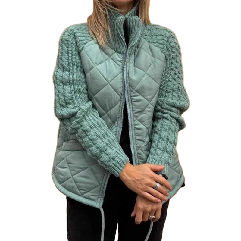 Person wearing a light blue quilted jacket against a beige wall.