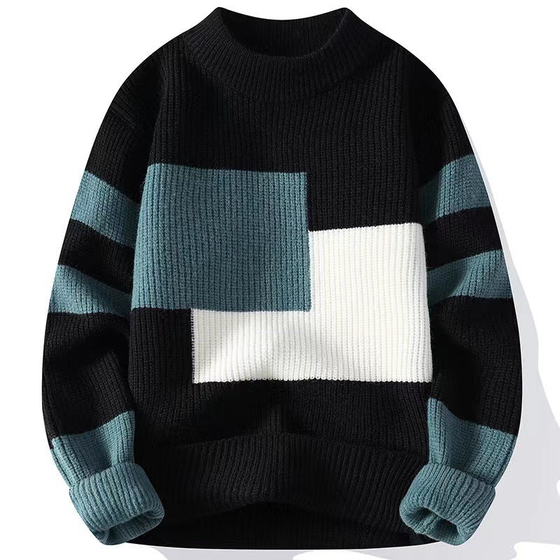 Color-blocked sweater with black, blue, and white design on a white background