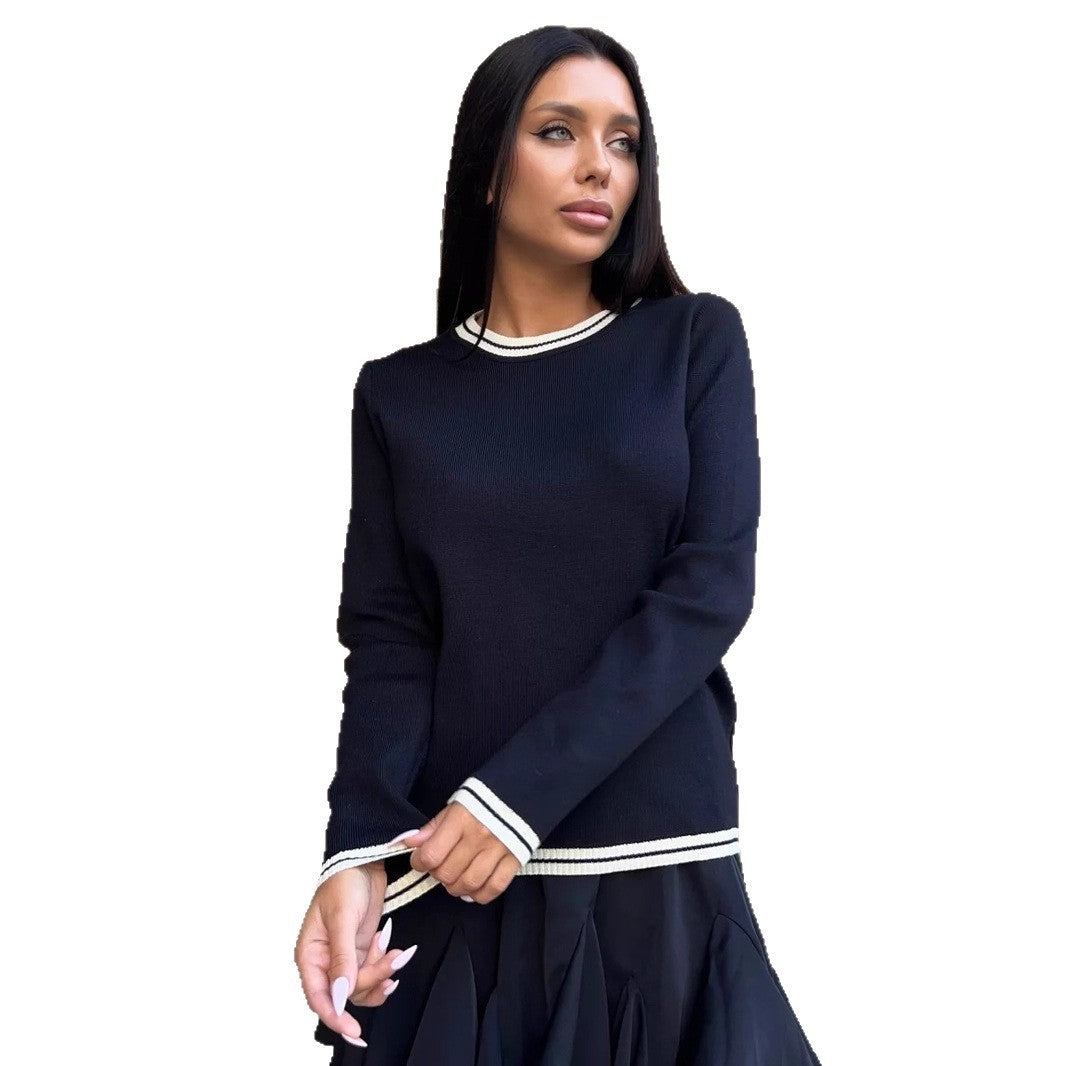 Woman wearing a navy blue dress with white trim on a white background