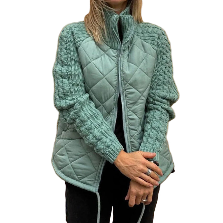 Teal quilted jacket worn by a person against a beige wall