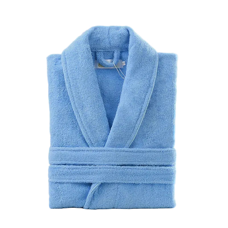 Blue robe folded on a white surface with decorative items in the background