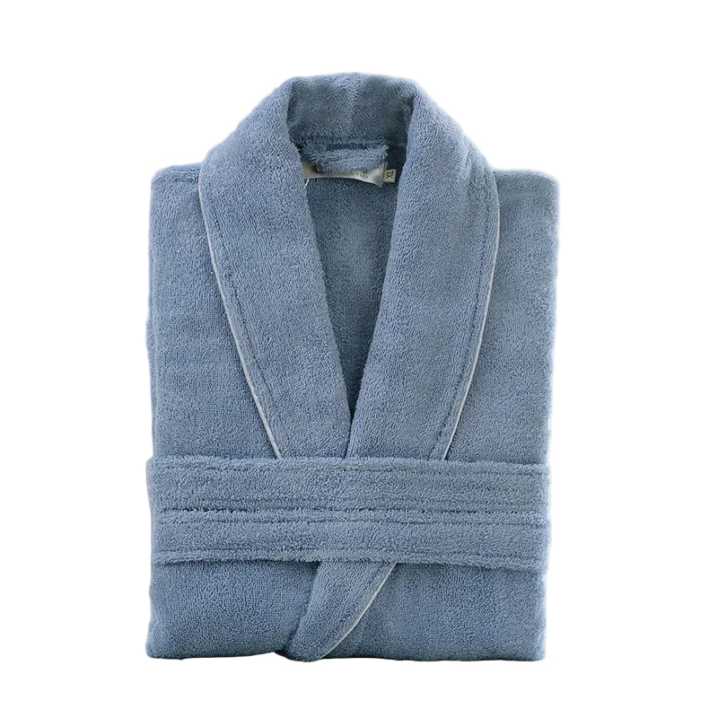 Folded blue robe on a white surface with a blurred background