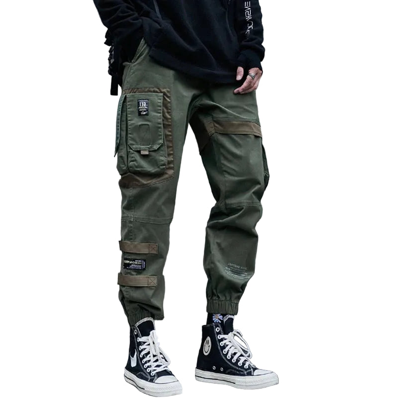 Person wearing green cargo pants and black sneakers on a concrete staircase, with 'CHAIENKOO' branding.