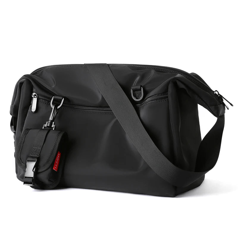 Black shoulder bag with a strap on a white background