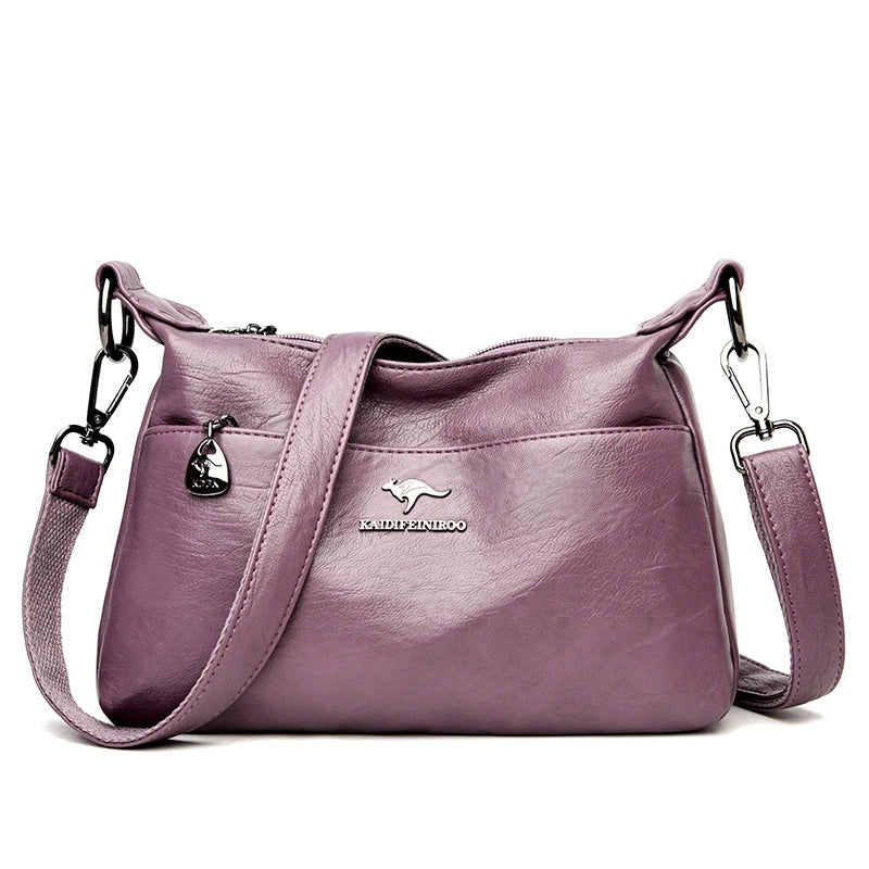 Purple handbag with a visible brand logo on a white background