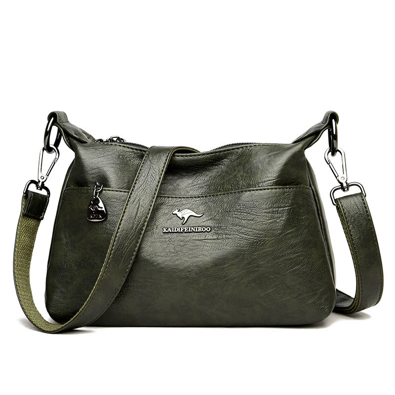 Green leather handbag with a visible brand logo on a white background