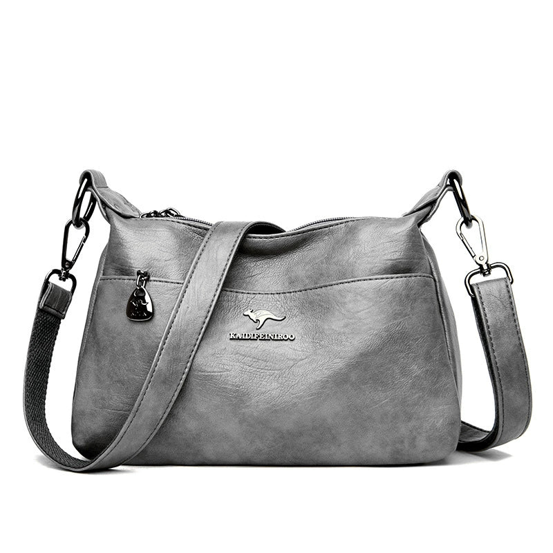 Gray handbag with a visible brand logo on a white background