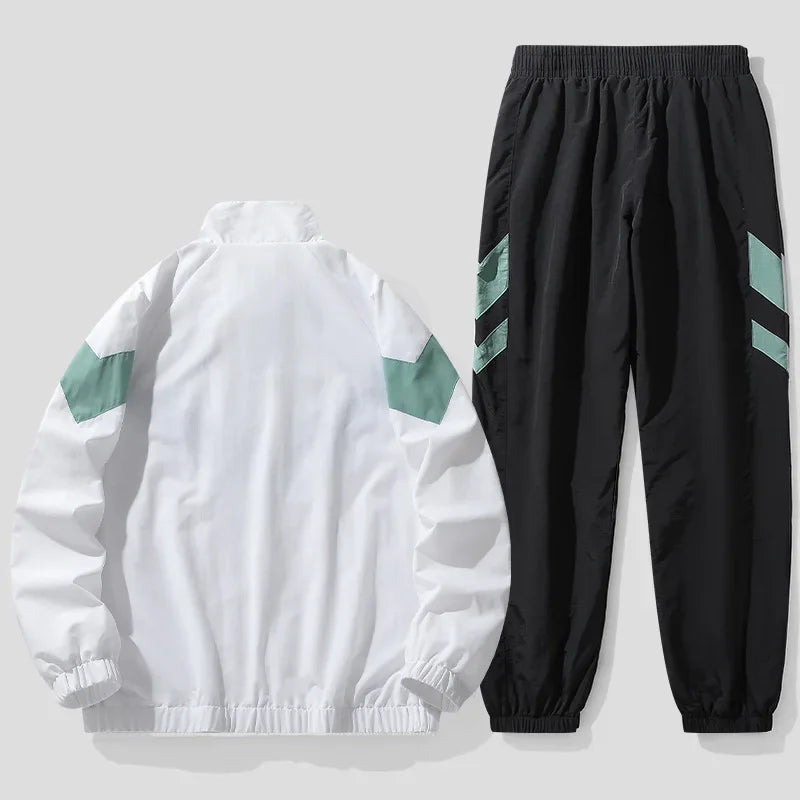 White jacket with green accents and black pants with green stripes on a light gray background