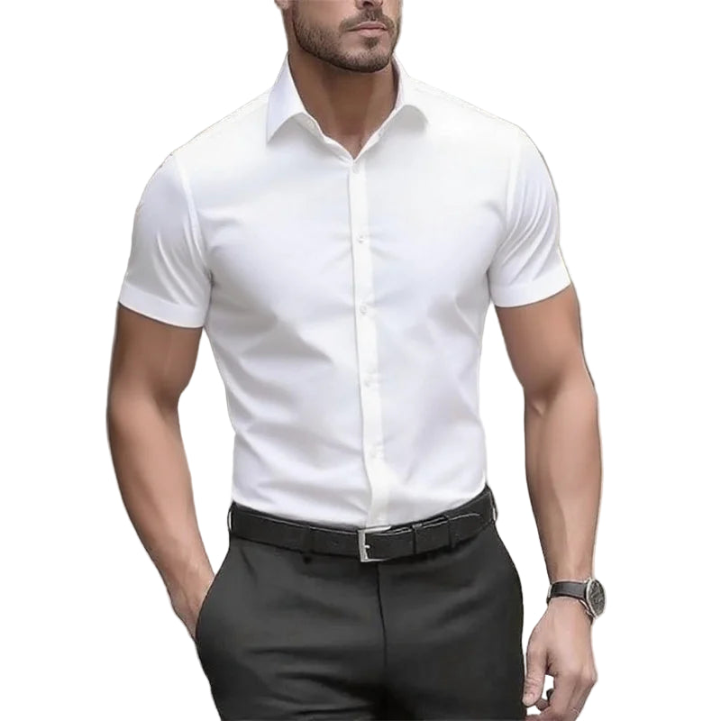Man wearing a white dress shirt and black pants with a blurred background