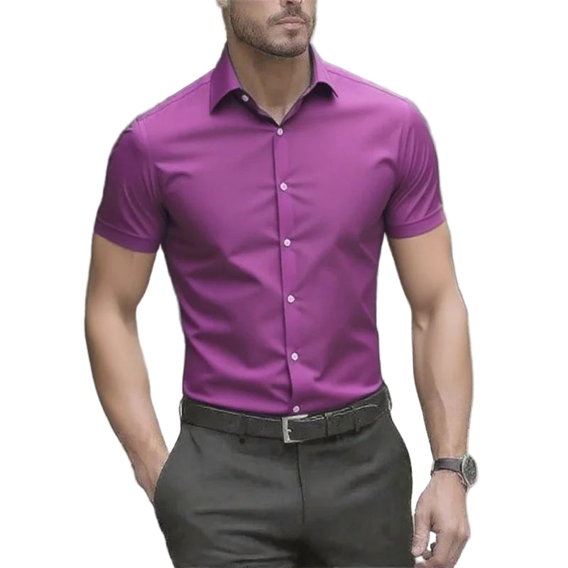 Man wearing a purple short-sleeve shirt and gray pants outdoors.