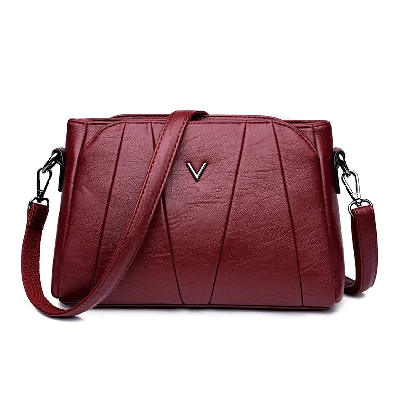 Red handbag with a visible brand logo on a white background
