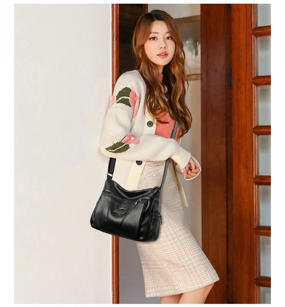 Woman holding a black handbag indoors
