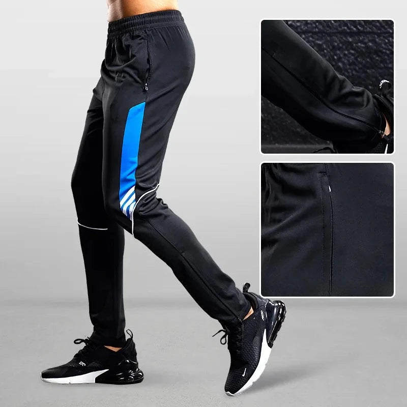 Black athletic pants with blue stripe and close-up details on a gray background