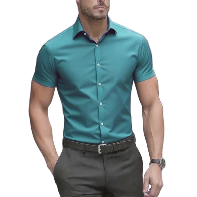Man wearing a teal short-sleeve shirt and dark pants outdoors