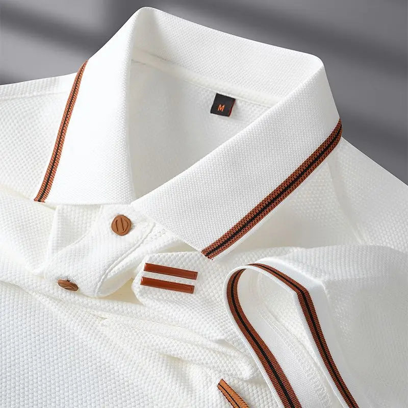 Close-up of a white shirt with brown accents on a gray background