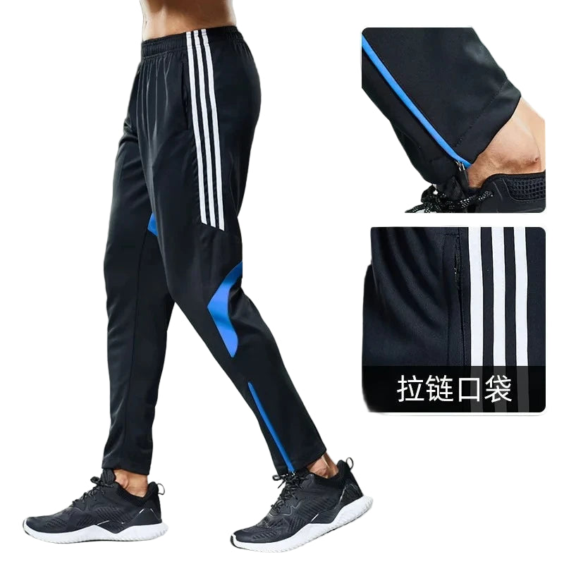 Black athletic pants with white stripes and blue accents on a gray background