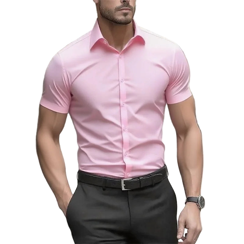 Man wearing a pink dress shirt and black pants on a blurred street background