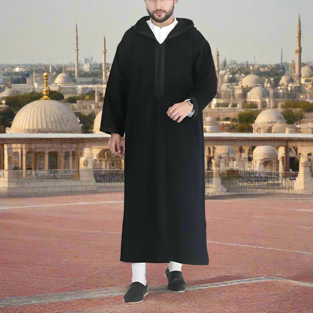 Person wearing a black robe on a white background