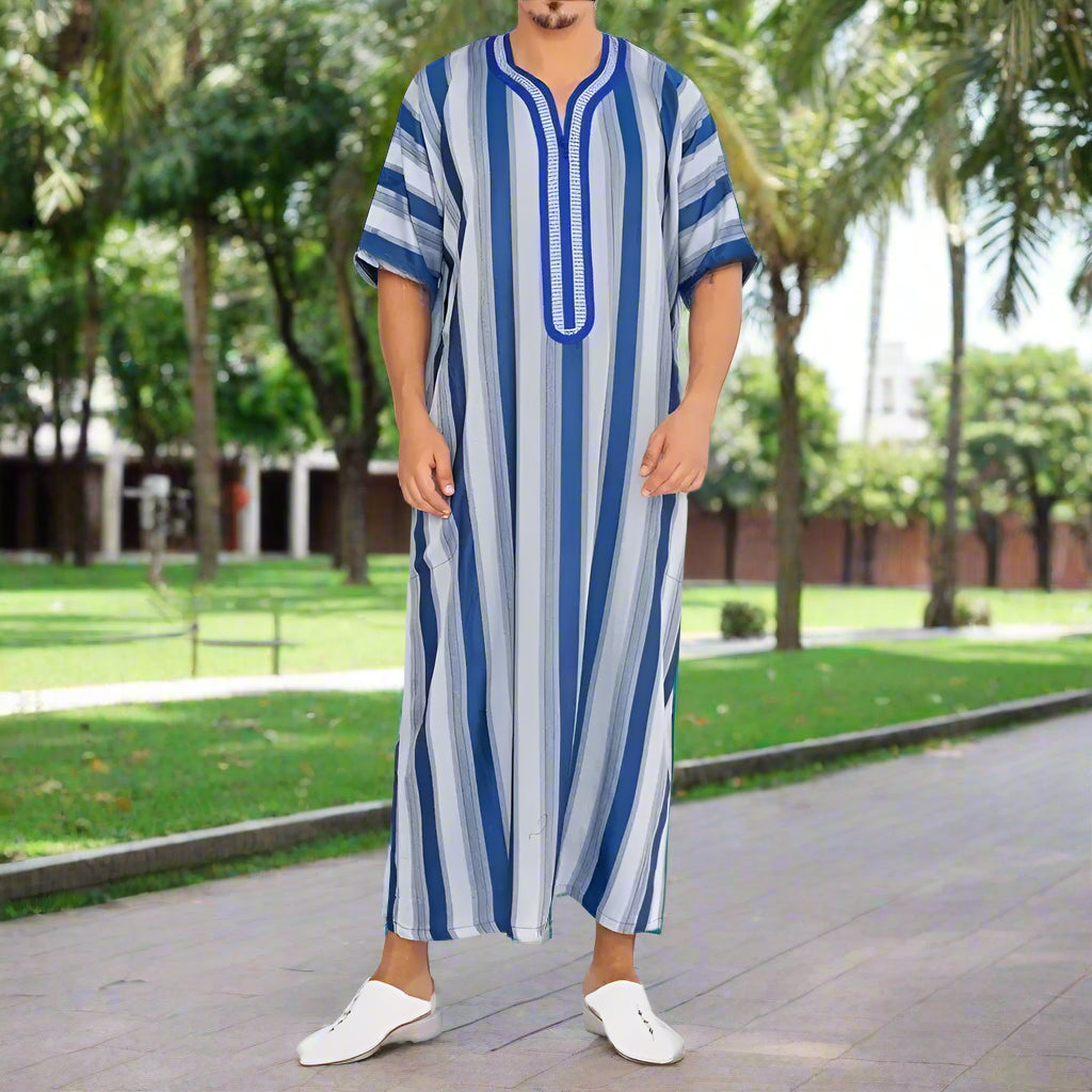 Person wearing a blue and white striped dress on a plain background