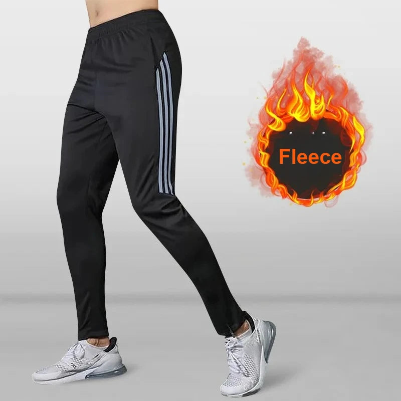 Black athletic pants with white stripes on a gray background, featuring an inset of flames with 'Fleece' text.