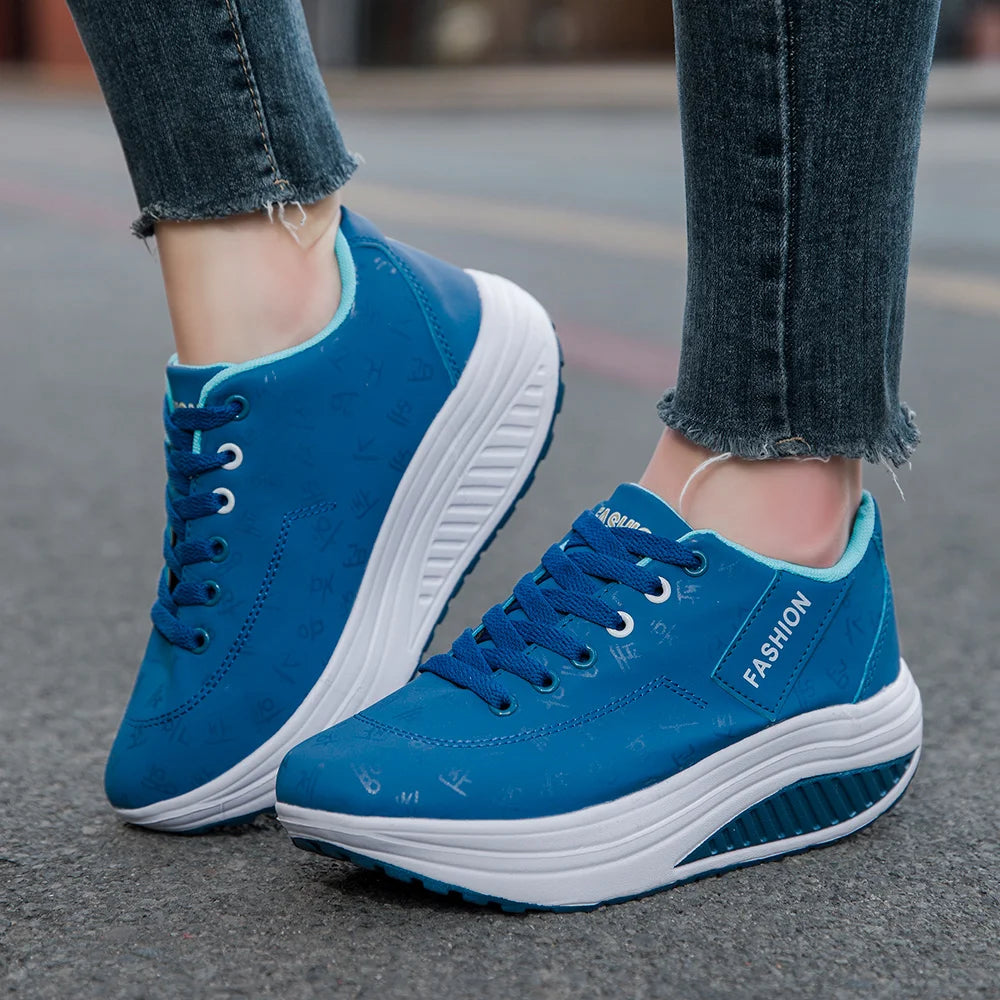 Blue sneakers with white soles worn on a street.