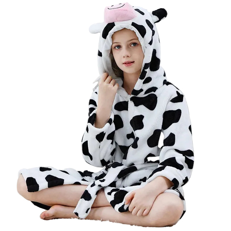 Person wearing a cow-themed onesie with a hood on a white background