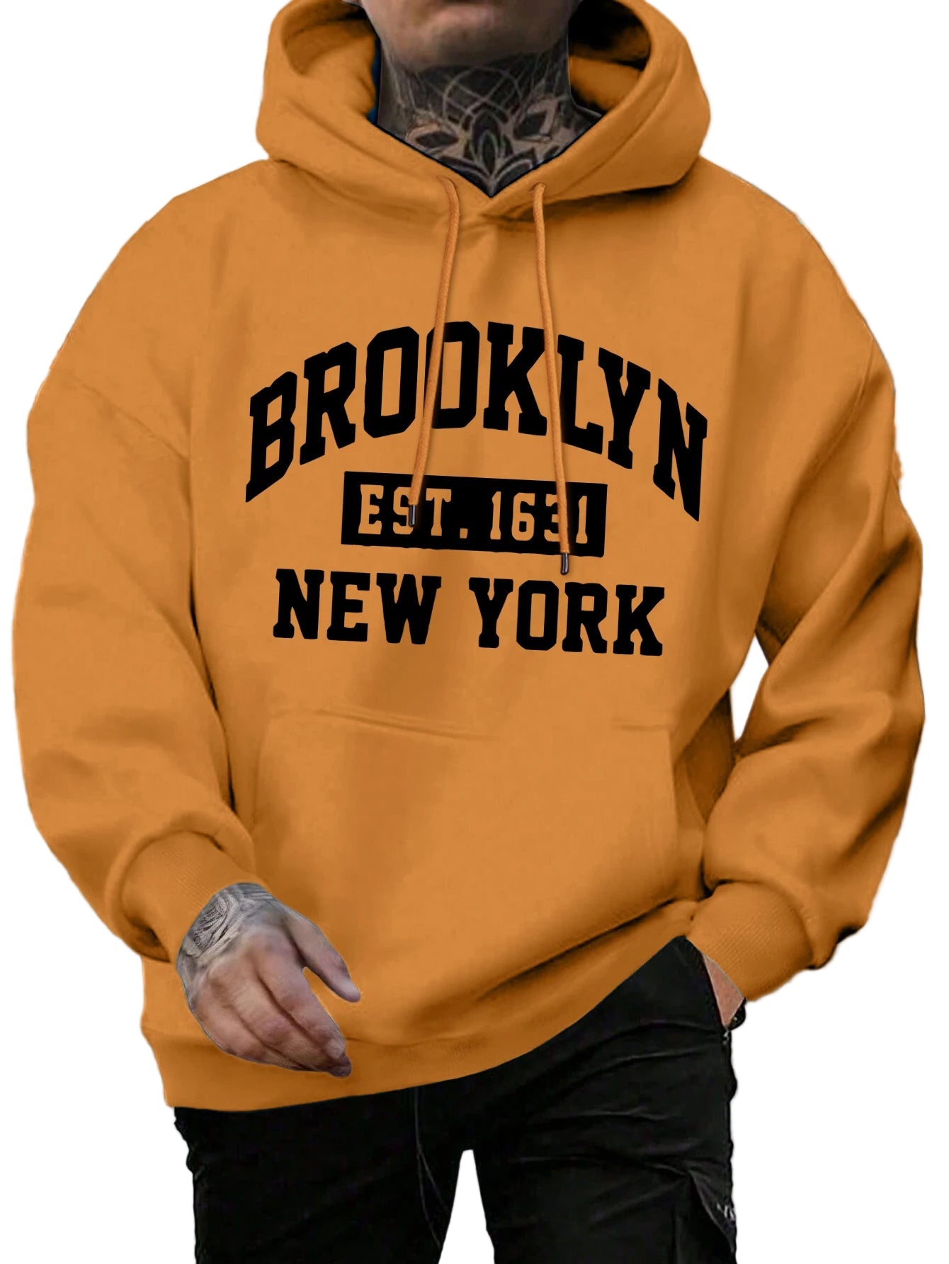 Person wearing a mustard yellow hoodie with 'Brooklyn Est. 1665 New York' text.