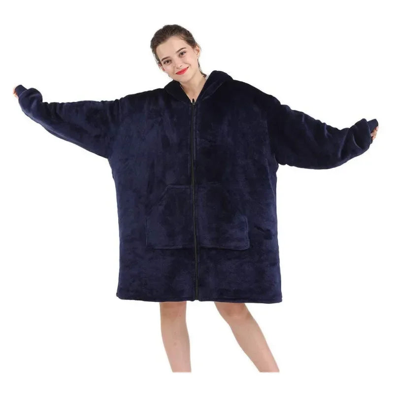 Person wearing a large navy blue fleece blanket with zippers on a white background