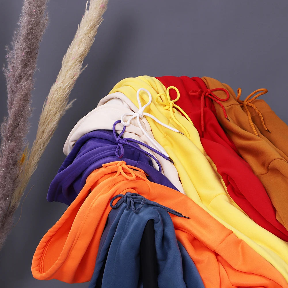 Stack of colorful drawstring bags against a gray background