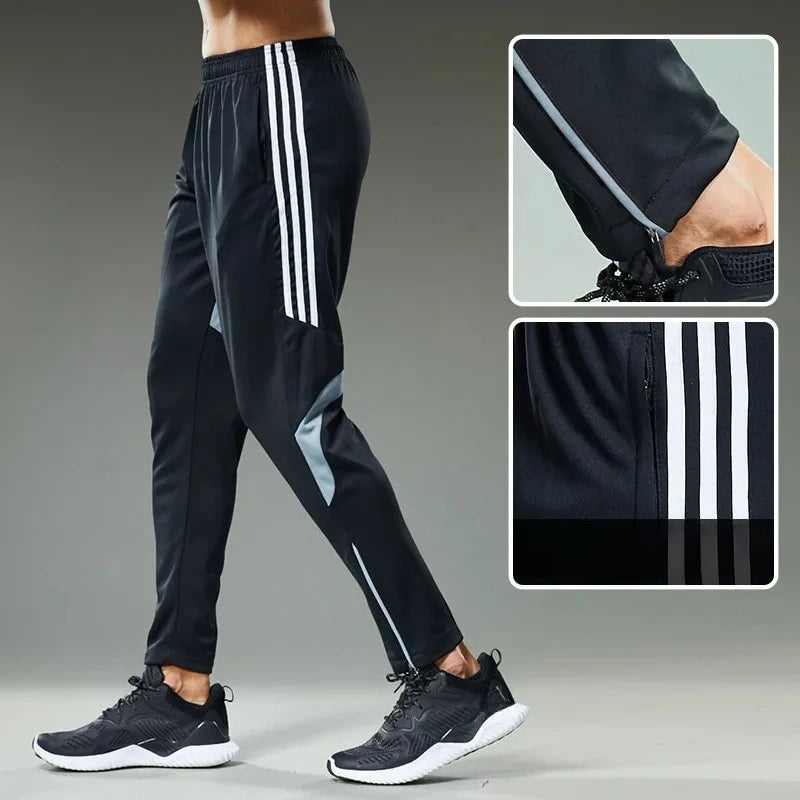 Black athletic pants with white stripes worn by a person on a gray background