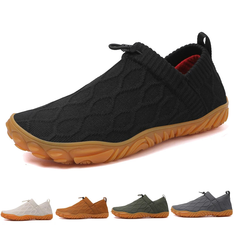Black slip-on shoes with brown soles on a white background