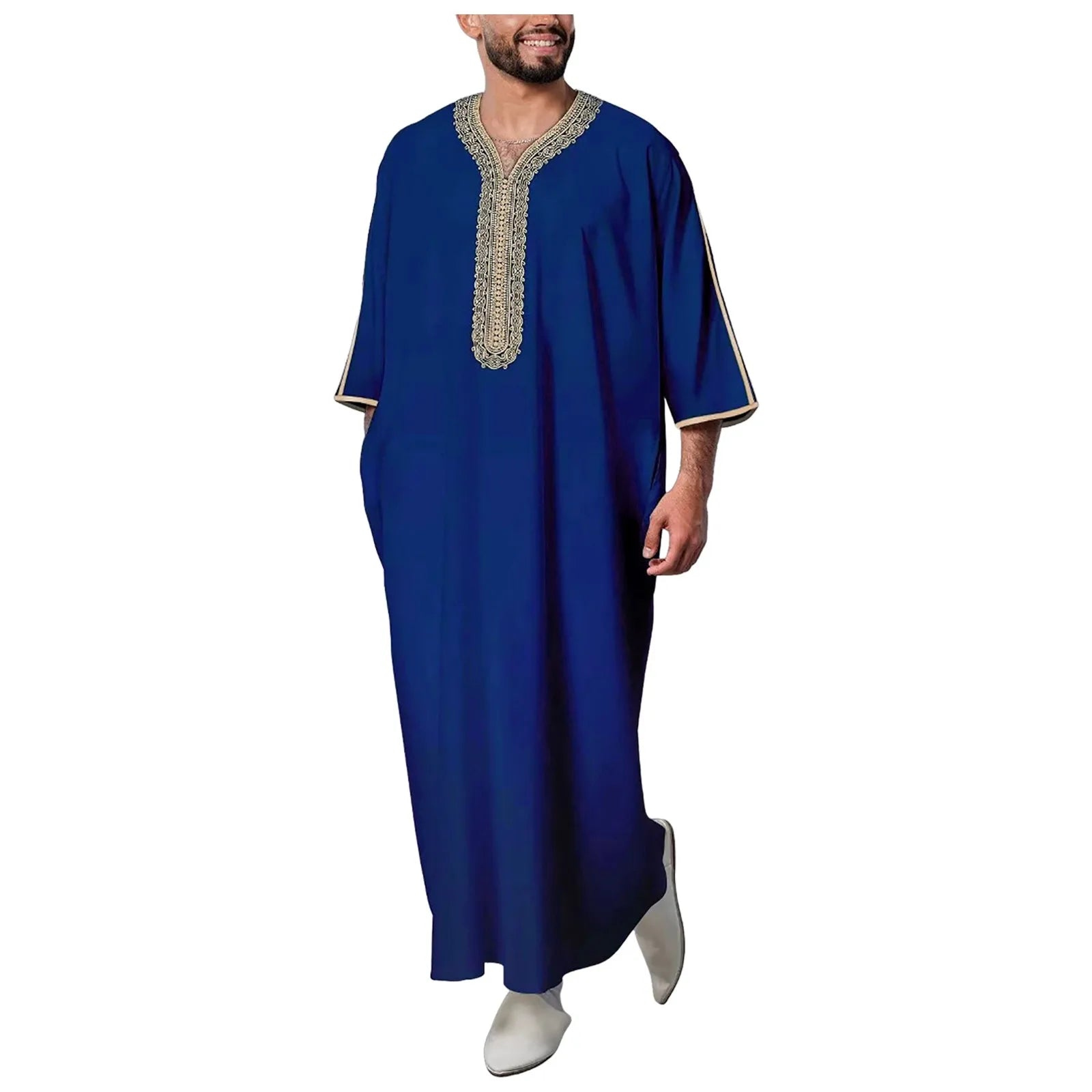 Man wearing a blue traditional outfit with white shoes on a white background