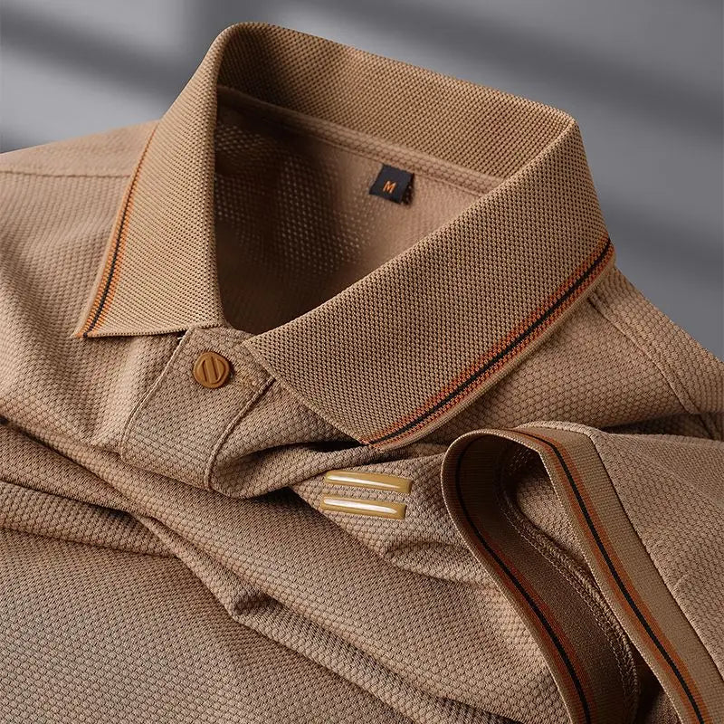 Close-up of a brown shirt with collar and button details on a gray background
