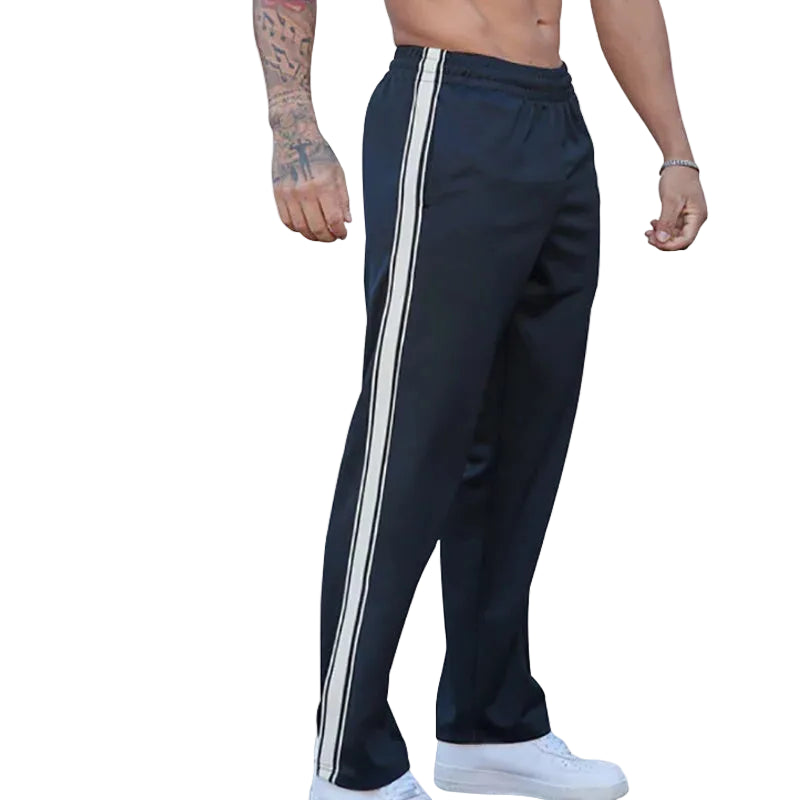 Navy track pants with white stripes on a white background