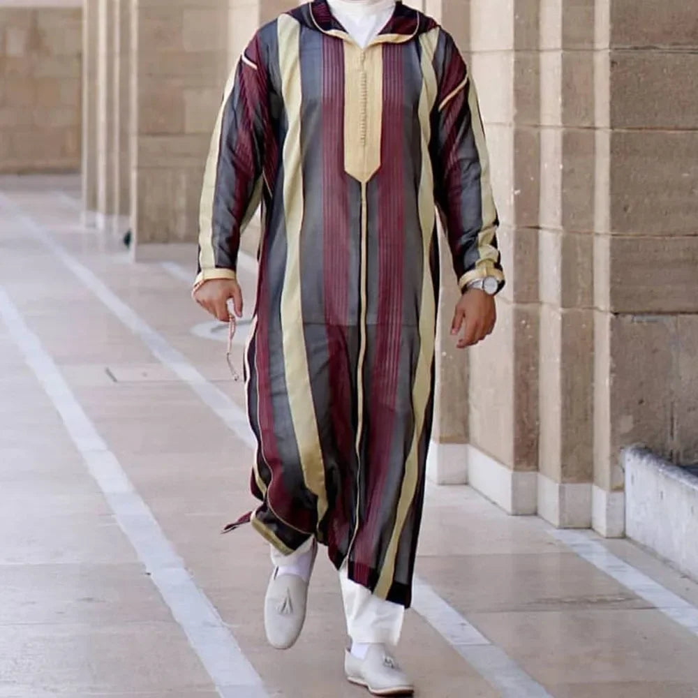 Person wearing a colorful striped outfit walking on a pathway.