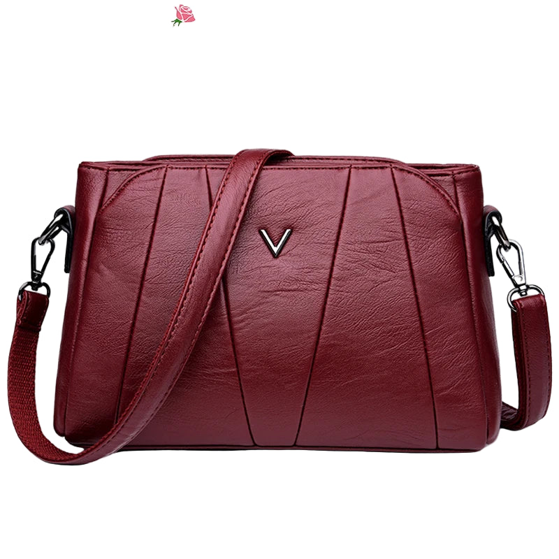 Red handbag with a visible brand logo on a white background