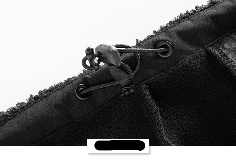 Close-up of a black jacket with zippers and buttons on a white background