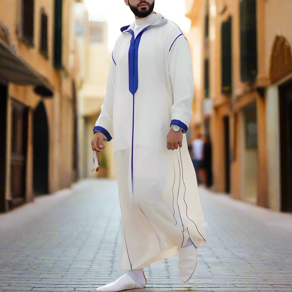 Person wearing a white and blue traditional outfit in an outdoor setting