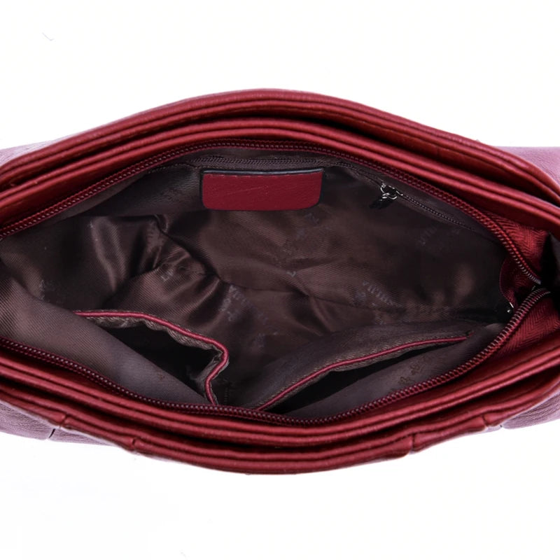 Red handbag with open lid showing interior on a white background
