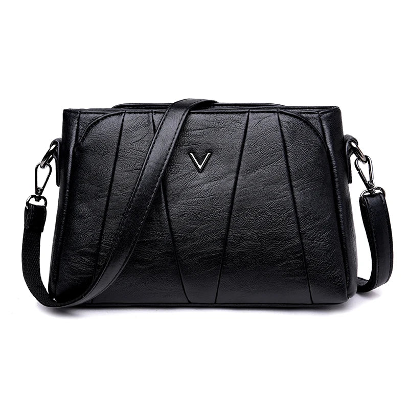 Black leather handbag with a visible brand logo on a white background