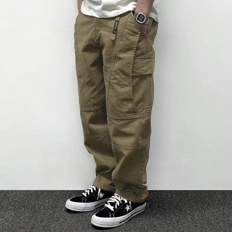 Person wearing khaki cargo pants with a white background