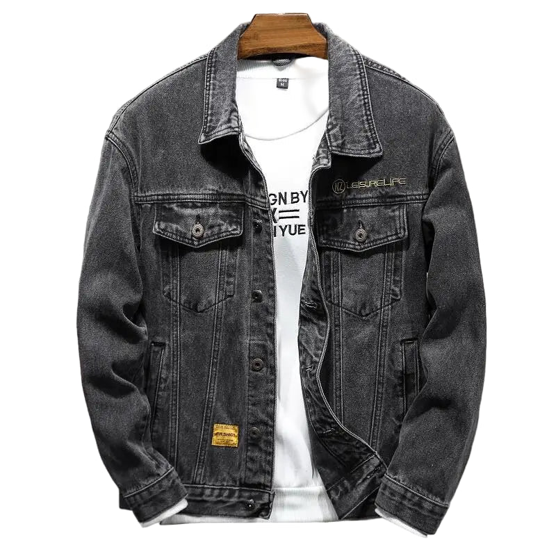 Black denim jacket on a hanger with a white shirt underneath against a gray background