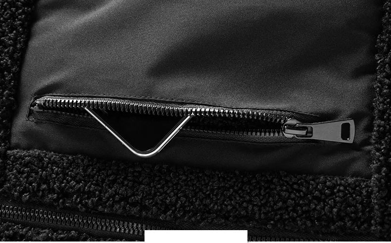 Close-up of a black jacket with a zipper pocket on a dark background