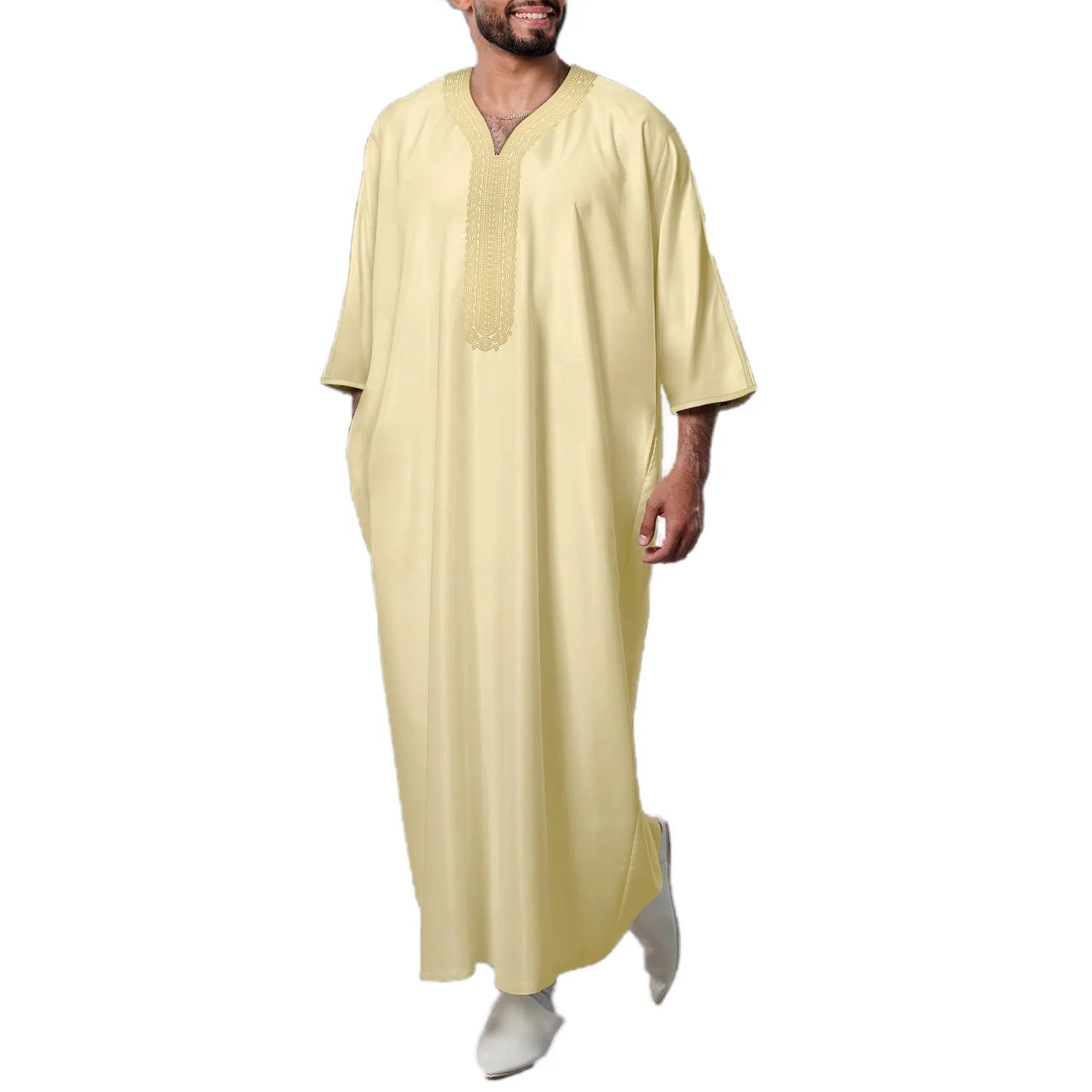 Man wearing a light yellow long-sleeve garment on a white background